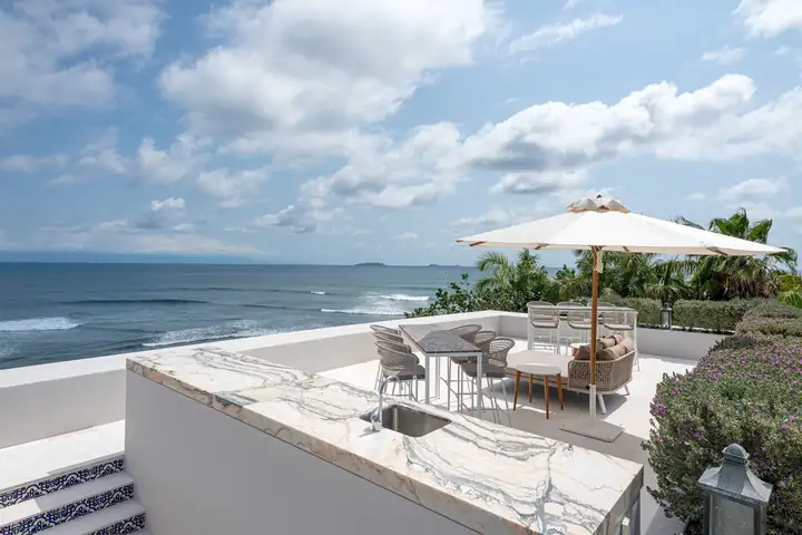 The rooftop bar at Casa Akai, set for sunset drinks with the islands on the horizon
