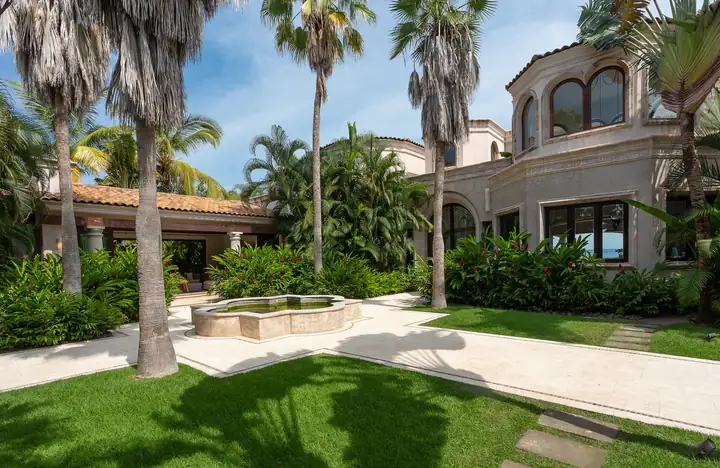The garden lawn, palms and fountain at Casa La Vida's entrance