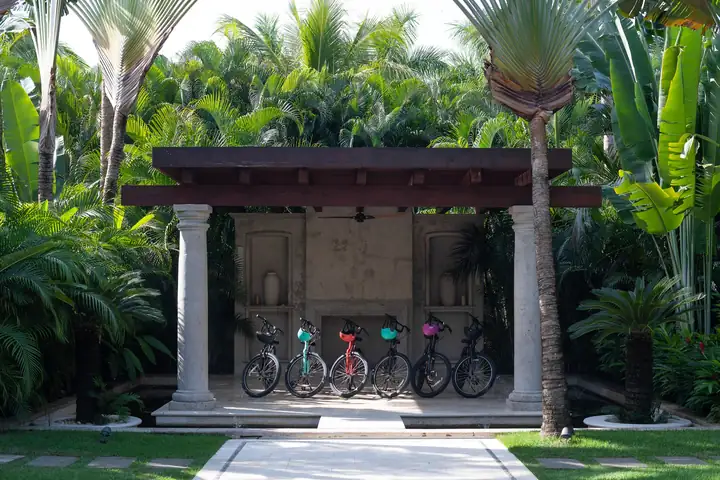 The garden pavilion among the palms at Casa La Vida, with the house bicycles for the resort paths