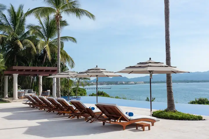 Loungers in a long row facing the bay at Casa La Vida