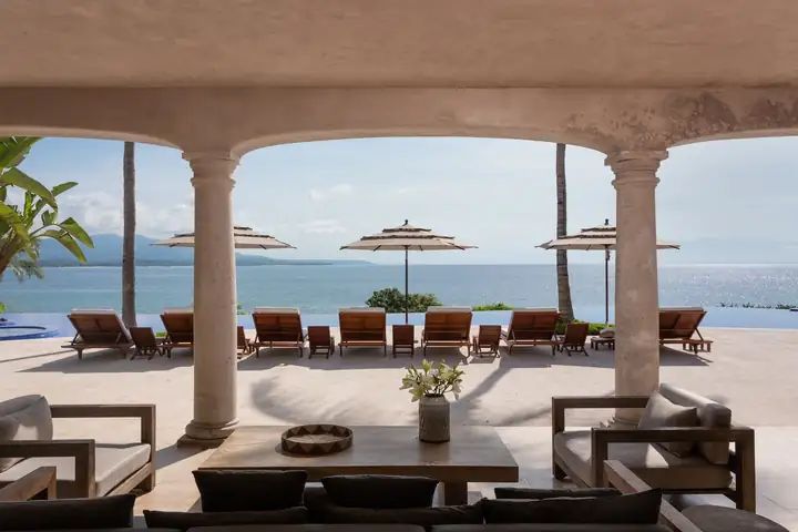 The terrace lounge under the stone arches at Casa La Vida, looking out to sea